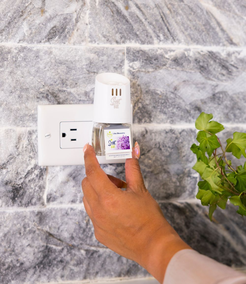 Lilac Blossom plug in refill natural air freshener plugged into kitchen outlet starter kit