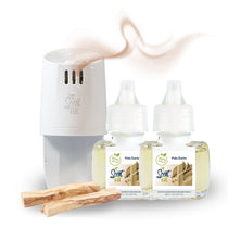 White Scent Fill plug-in diffuser releasing a soft tan fragrance mist beside two Palo Santo refill bottles, with palo santo wood pieces on a light background.