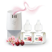 Scent Fill Cherry Blossom plug-in air freshener warmer with two refill bottles, shown with pink cherry blossoms, red cherries, and a soft fragrance swirl on a white background.