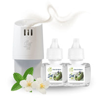 White Scent Fill plug-in diffuser releasing a soft white fragrance mist beside two Clean Air Blend refill bottles, with green mint leaves and white jasmine flowers on a light background.