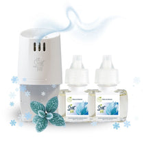 Scent Fill Natural Glacier plug-in air freshener warmer with two refill bottles, shown with frosted leaves, snowflakes, and a cool fragrance swirl on a white background.
