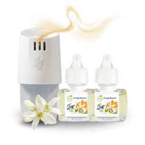 Scent Fill plug-in diffuser with two Orange Blossom fragrance refill bottles and a white blossom flower, with a soft golden scent trail above the diffuser.