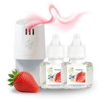 White Scent Fill plug-in diffuser releasing a soft pink fragrance mist beside two Strawberry refill bottles, with a fresh strawberry on a light background.