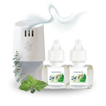 Scent Fill Eucalyptus Spearmint plug-in air freshener set on a white background, featuring a white Scent Fill diffuser unit with a blue indicator light emitting illustrated scent waves, two Eucalyptus Spearmint refill bottles (0.68 fl oz / 20ml each) displayed side by side in front of the unit, and fresh eucalyptus branches and spearmint leaves arranged to the left to represent the fragrance.