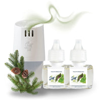 Scent Fill plug-in diffuser with two Fraser Fir & Balsam Pine refill bottles displayed beside evergreen sprigs and pinecones, with a soft green scent trail rising above.