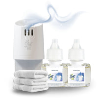 White Scent Fill plug-in diffuser releasing a soft blue fragrance mist beside two Fresh Linen refill bottles and a stack of folded white towels on a light background.