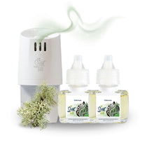 Scent Fill plug-in diffuser with two Oakmoss fragrance refill bottles on a white background, paired with soft green-gray moss, with a light scent trail flowing above the diffuser.