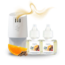 Scent Fill plug-in diffuser with two Orange Clove fragrance refill bottles, an orange slice, and whole cloves, with a soft golden scent trail above the diffuser.