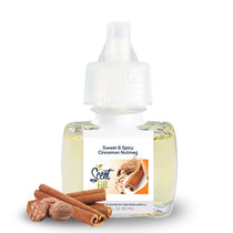 Scent Fill Sweet & Spicy Cinnamon Nutmeg plug-in air freshener refill bottle with pale liquid, white cap, and cinnamon sticks with whole nutmeg on a light background.