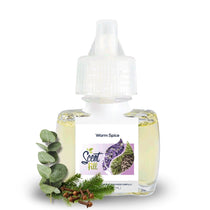 Warm Spice plug-in refill bottle displayed with eucalyptus leaves, evergreen sprigs, and cloves on a clean white background.