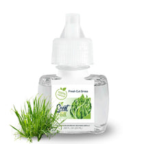 Scent Fill Fresh Cut Grass plug-in refill bottle with a tuft of green grass on a light background.